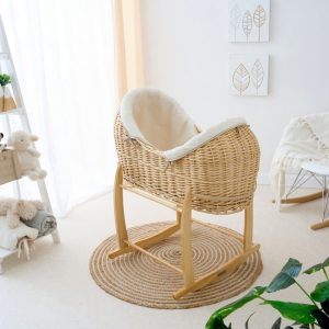 MOSES BASKETS Clair de Lune organic Noah Pod made from natural willow wicker with a cream organic cotton padded dressing, a sheet and bamboo mattress.